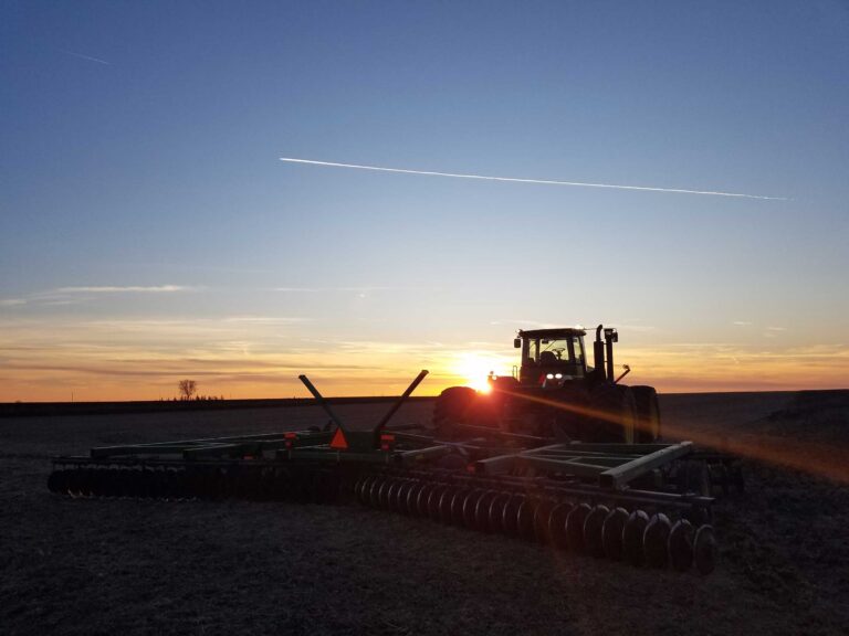 Farmland auction in progress with live and online bidders in Iowa